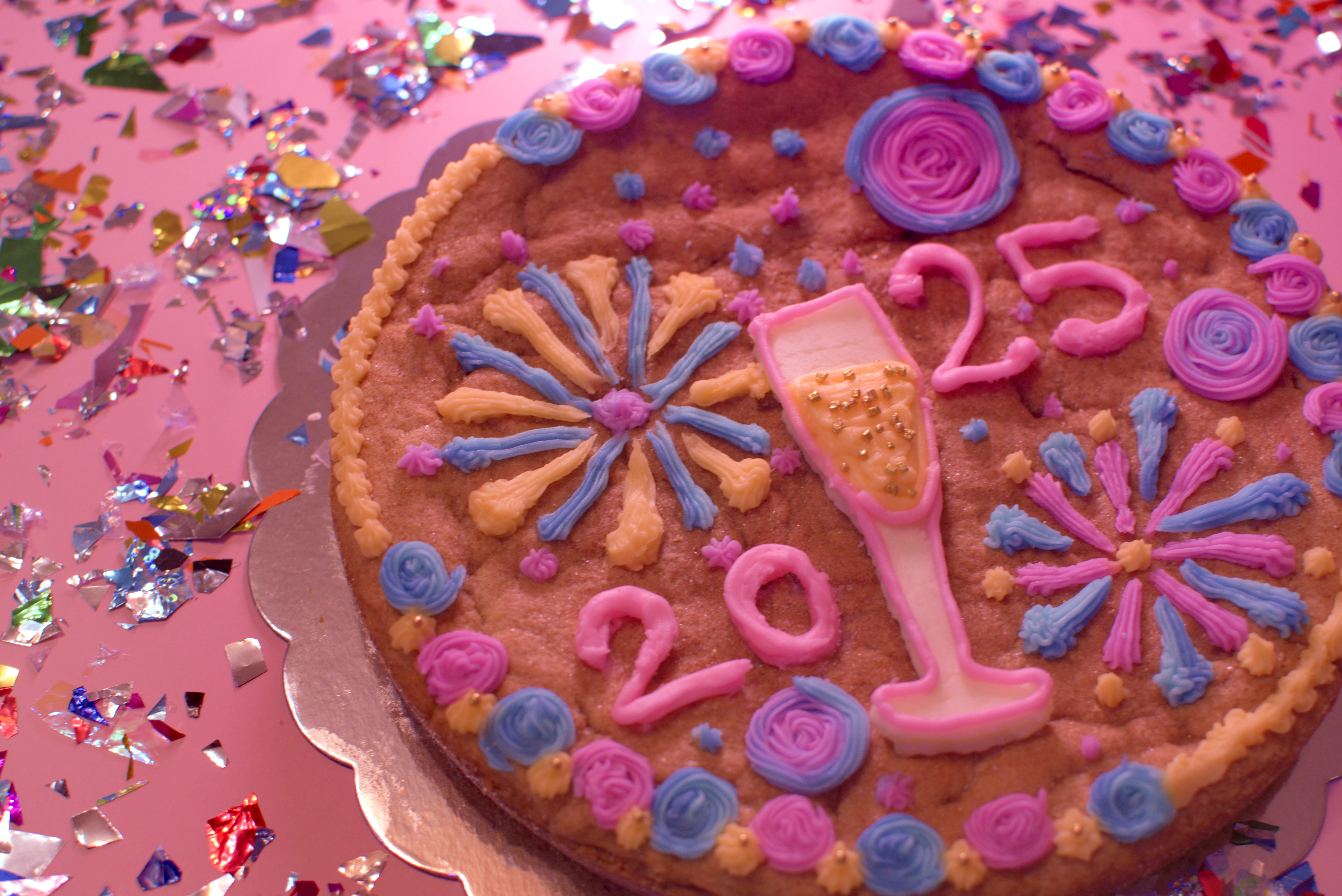 Large decorated custom cookie cake with sprinkles and piped frosting